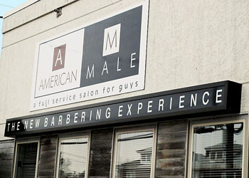 Exterior of Reading, PA men's hair salon entrance with American Male sign 
